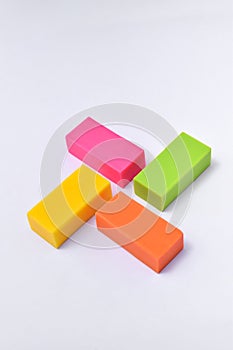 Colorful eraser. Pink, green, yellow and orange