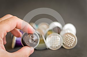 Colorful espresso coffee capsules used on black background, recycling, environment