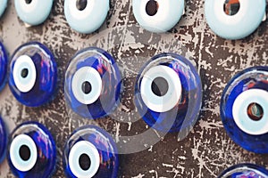 Colorful evil eye beads displayed on a textured surface