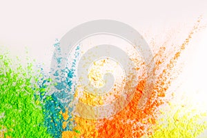 Colorful explosion of holi dust on white background