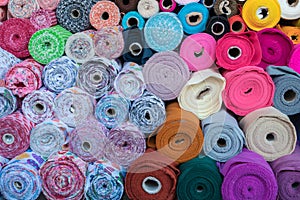 Colorful fabric rolls at market.