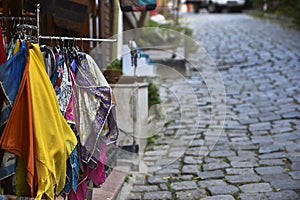 Colorful Fabrics in an Old Cobblestone Street
