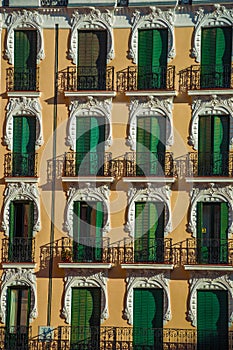 Colorful facade and windows with closed shutters in Madrid