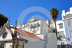 Colorful facades in Alfama neighborhood with a Russian Orthodox Church Ortodoxa Russa in the foreground, Lisbon, Portugal photo