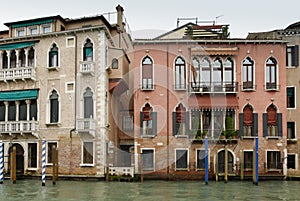 Colorful facades of old medieval and historical houses along Grand Canal in Venice, Italy. Venice is situated across a group of 11