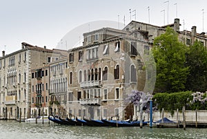 Colorful facades of old medieval and historical houses along Grand Canal in Venice, Italy. Venice is situated across a group of 11