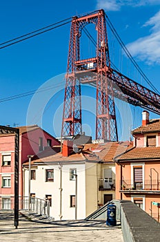 Colorful facades in Portugalete old town, with the famous Vizcaya Bridge in the background