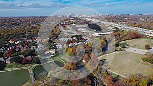 Colorful fall foliage at Park Central with luxury lakeside residential houses, soccer fields, White Rock Creek near major highways