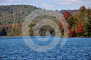 Colorful fall leaves decorate the shores of Hunters Lake near Eaglesmere Pennsylvania