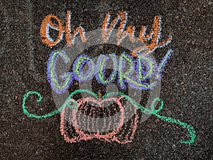 Colorful fall-themed chalk art on a driveway that says, Oh my gourd! with a pumpkin underneath.