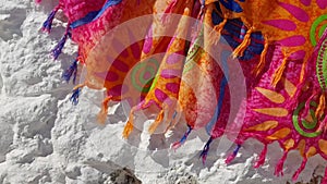 Colorful fashion background of silk fabric with tassels shaking in wind. Summer scarf with fringe