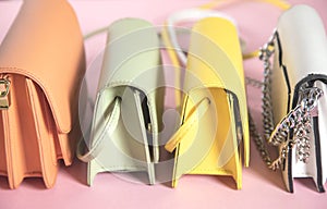 Colorful fashion handbags on table