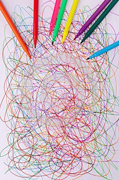 Colorful felt tip pen and abstract scribble on white paper.