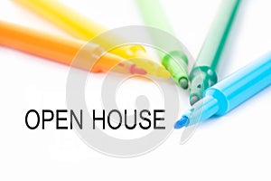 Colorful felt-tip pen and open house word on white background
