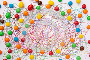 Colorful felt tip pen scribble and sweets on white paper.