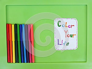Colorful Felt Tip Pens isolated on a green background. Color your life concept