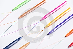 Colorful felt-tip pens on white background with connected drawn lines, connection and communication concept.