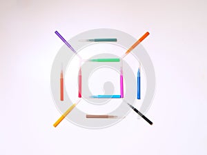 Colorful felt-tip pens on the white background. Markers pattern in the shape of square. Background or texture
