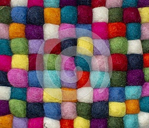 Colorful felted little balls full frame