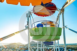 Colorful ferris wheel of the amusement park in the blue sky background Close up view