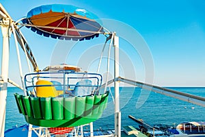 Colorful ferris wheel of the amusement park in the blue sky background Close up view