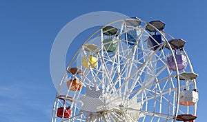 Colorful ferris wheel on the background of blue sky