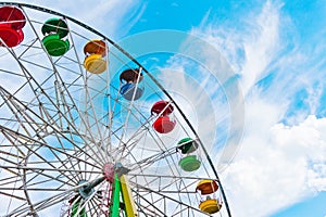 Colorful ferris wheel on blue sky background