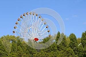 Colorful ferris wheel on blue sky background