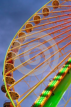 Colorful ferris wheel at carnival fair from below