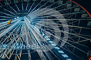 Colorful ferris wheel at night, close view