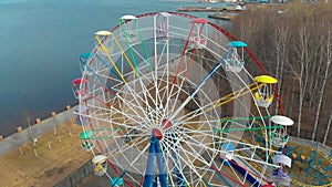 Colorful ferris wheel in a park of culture and rest on a spring day, flying shot