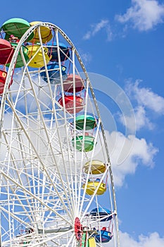Colorful ferris wheell against blue sky