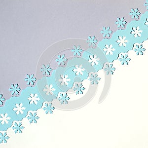 Colorful festive background with cut out snowflakes