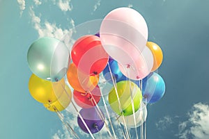 Colorful festive balloons over blue sky