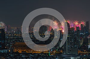 Colorful Firework with cityscape night light view of Bangkok skyline at twilight time