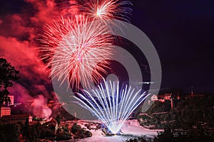 Colorful firework over the Rhine Falls to celebrate traditionally the Swiss National Day