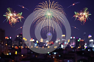 Colorful fireworks display on city bokeh background