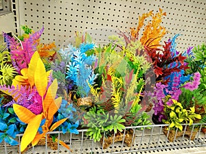 Colorful Fish Aquarium Fake Plants on a Dusty Store Shelf