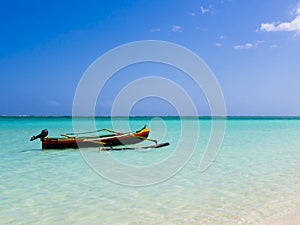 Colorful fishermen pirogue moored on turquoise sea of Nosy Ve island, Indian Ocean, Madagascar