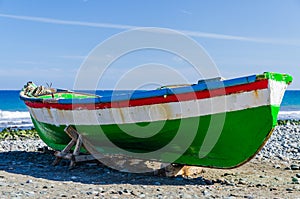 Colorful fishing boat on the beach at the Atlantic Ocean