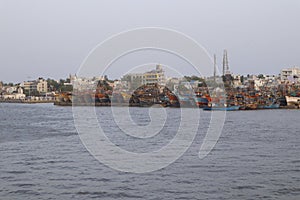 colorful fishing boat on the coast. Fishing boats on the shallows and view of the village.