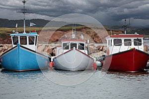 Colorful fishing boats moored at the pier in Havre Aubert in Quebec, Canada