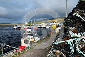 Colorful fishing boats and yachts at the harbor of Portmagee town on the West Atlantic coast of Ireland.