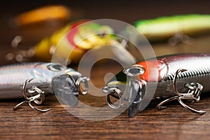 Colorful fishing lures, wobbler, spinner, on wood desk different fishing baits