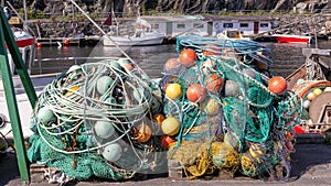 Fishing nets, colorful buoys on the quay of the Norwegian marina photo