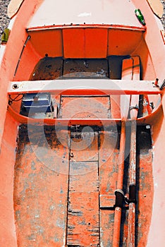 Colorful fishing wooden boat moored on the beach,coral color