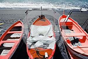 Colorful fishing wooden boat moored on the beach,coral color