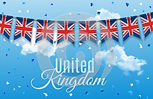 Colorful flag garlands of Great Britain, United Kingdom with confetti on blue sky with clouds background. Festive
