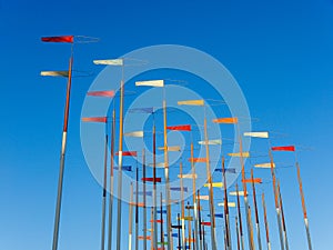 Colorful flags on a blu sky background