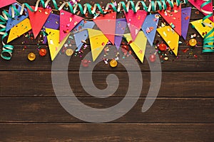 Colorful flags garland on wooden background